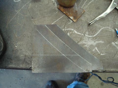 1996 Ford Bronco - A metal component marked with chalk lines sits on a workbench, ready for fabrication.