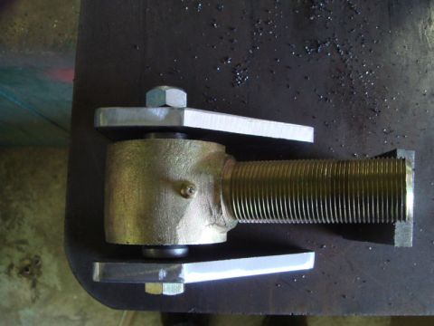 1996 Ford Bronco - Close-up of a metal hinge component with a threaded rod and bolt.