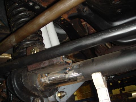 1996 Ford Bronco - Close-up view of the undercarriage, showing suspension components and newly welded brackets.