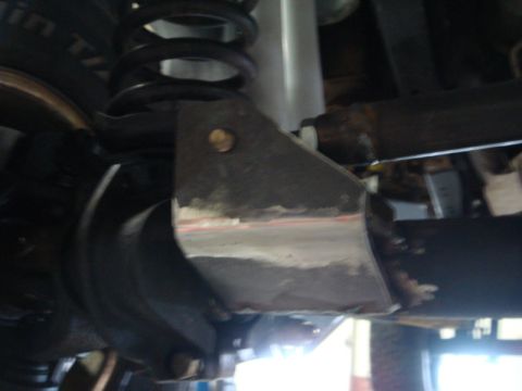 1996 Ford Bronco - Welded suspension bracket on a vehicle's rear axle assembly.