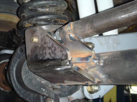 1996 Ford Bronco - Custom suspension components are visible, including a coil spring and metal linkage with bolts and welds.