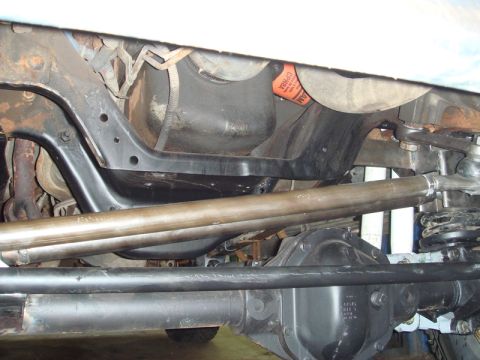1996 Ford Bronco - Close-up of vehicle undercarriage components, including steering and suspension parts.