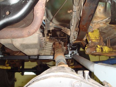 1996 Ford Bronco - Close-up view of the undercarriage of a vehicle, highlighting the transmission and suspension system.