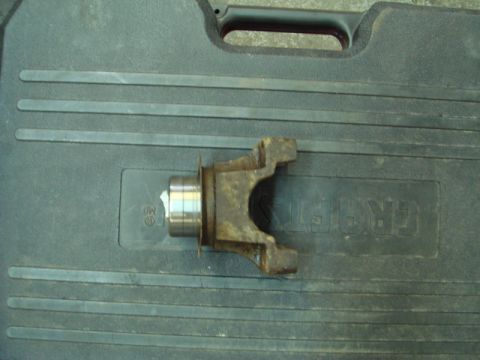 1996 Ford Bronco - A close-up of a rusty driveshaft yoke resting on a Craftsman toolbox.