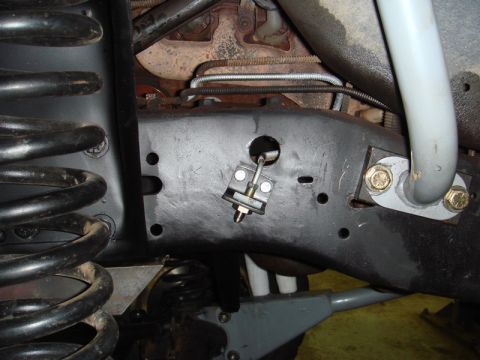 1996 Ford Bronco - Detailed view of the undercarriage of a vehicle, focusing on the frame and suspension system.