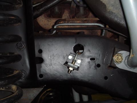 1996 Ford Bronco - Detail of the vehicle's frame and suspension system, showing a bracket for a brake line.