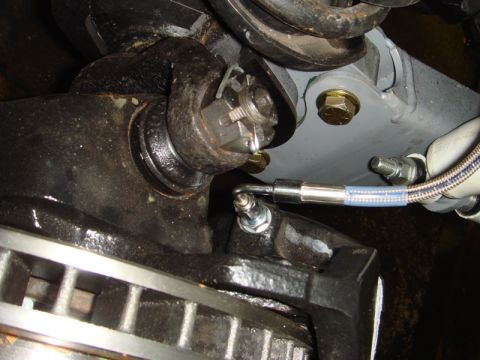 1996 Ford Bronco - Detail of a vehicle's suspension system, focusing on the ball joint and brake assembly.