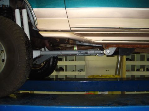 1996 Ford Bronco - Undercarriage view of a 1996 Ford Bronco, highlighting its suspension components while elevated on a lift.