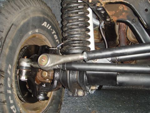1996 Ford Bronco - The front suspension and steering system of a vehicle is shown in this close-up detail shot.