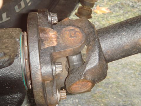 1996 Ford Bronco - A close-up view of a vehicle's driveshaft universal joint, showing signs of wear and rust.