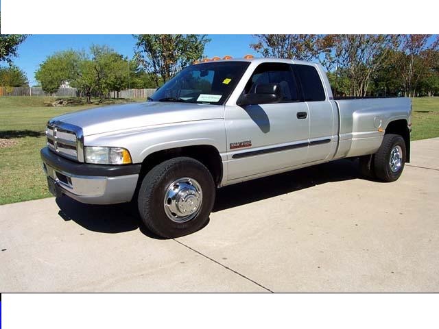 Silver Dodge Ram 3500 dually pickup truck, 1994 model year. Chrome grille and wheels