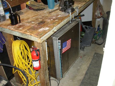 1995 Ford Bronco - Workbench setup with tools, extension cord, fire extinguisher, and a mini-fridge with an American flag sticker.