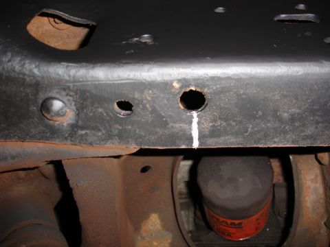 1996 Ford Bronco - Underside view of a vehicle's frame, showing rust and an oil filter.