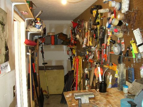 1995 Ford Bronco - This garage workshop is filled with tools, supplies, and equipment, suggesting a space dedicated to projects and repairs.