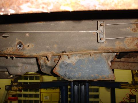 1996 Ford Bronco - Underbody view showing significant rust on the vehicle's frame and suspension components.