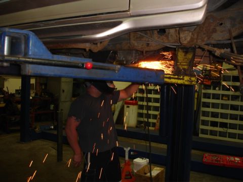 1996 Ford Bronco - Undercarriage work in progress with sparks flying from a grinder.