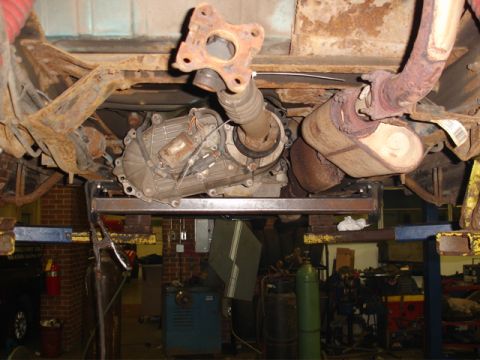 1996 Ford Bronco - The underside of a vehicle is shown, with focus on the transmission and exhaust components.