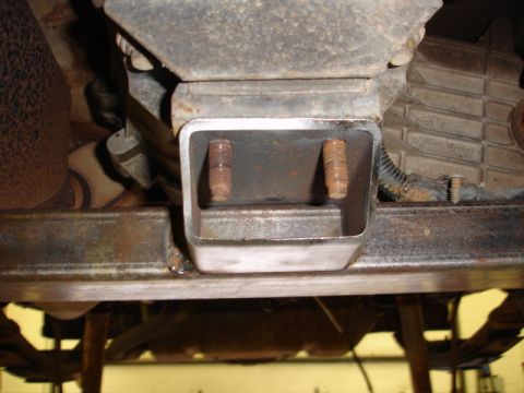 1996 Ford Bronco - Close-up view of a vehicle's underbody, focusing on a metal bracket and bolts.