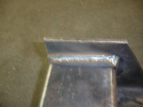 1996 Ford Bronco - A close-up view of a metal joint that has been welded, with visible heat discoloration.