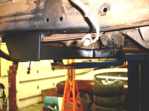 1996 Ford Bronco - Close-up of a vehicle's undercarriage with a black component attached to the frame.