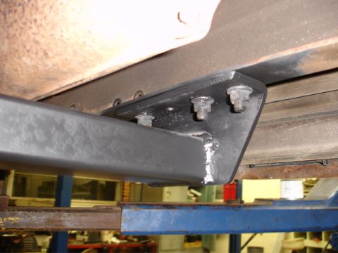 1996 Ford Bronco - Close-up view of a frame mount attached to the underbody of a vehicle.
