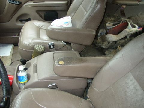 1995 Ford Bronco - Interior view of a 1995 Ford Bronco, showing the seats, console, and various items.