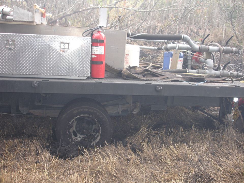 Side view of flatbed truck with diamond plate toolbox and fire extinguisher
