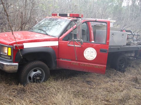 1989 Ford Bronco - This truck has "FIRE DEPARTMENT" written on its side and a circular emblem on the door.