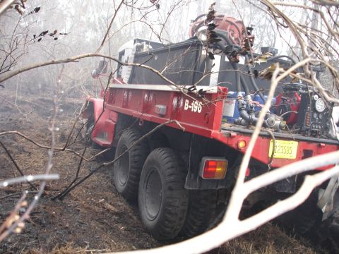1989 Ford Bronco - A red fire truck navigates through a wooded area, possibly responding to a fire.