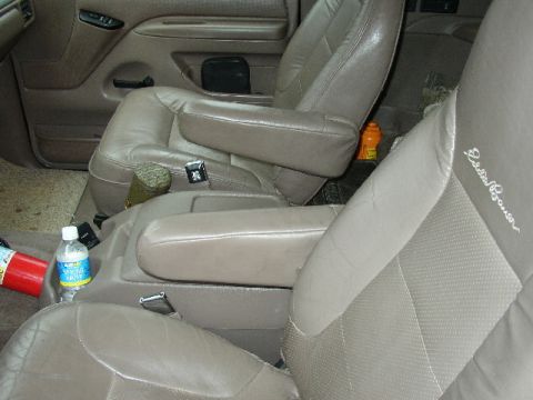 1995 Ford Bronco - Interior view of car seats, with a bottle of water and a fire extinguisher visible. Eddie Bauer badging on the seat.
