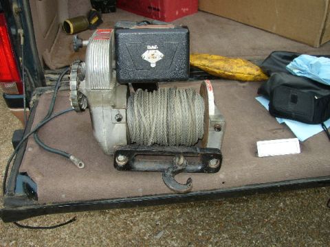 1995 Ford Bronco - A winch with a steel cable and hook is visible, likely installed in the cargo area of a vehicle.