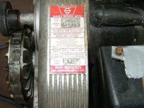 1995 Ford Bronco - Close-up of a Warn Industries winch part, detailing its model and specifications.