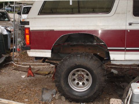 1989 Ford Bronco - This 1989 Ford Bronco shows its rear quarter panel and large off-road tires, suggesting it is undergoing modifications.