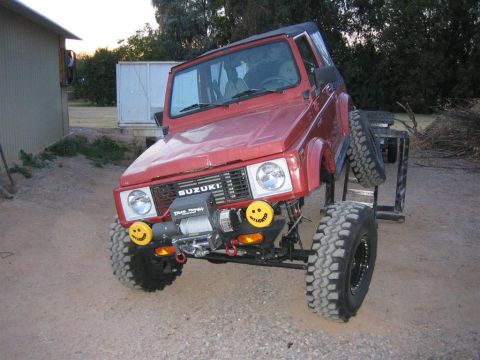 1987 Suzuki Samurai - This red 1987 Suzuki Samurai is equipped with a winch and decorative smiley face lights on the bumper.