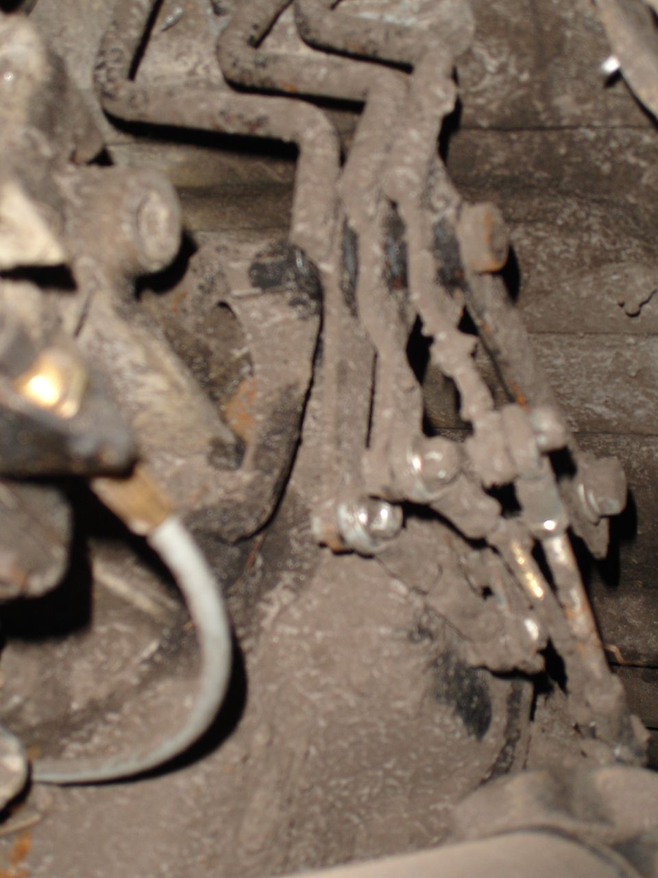 Close-up of rusty brake lines and suspension parts