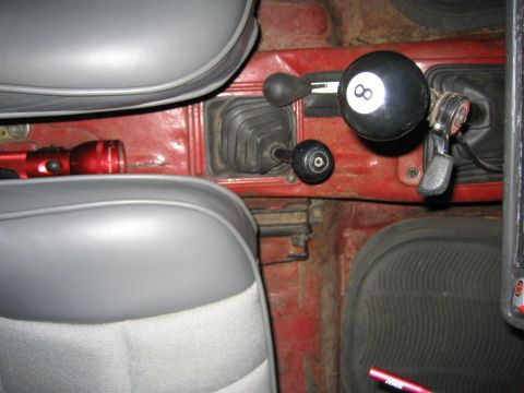 1987 Suzuki Samurai - The interior features dual gear shifters and a custom 8-ball shift knob, along with a red flashlight.