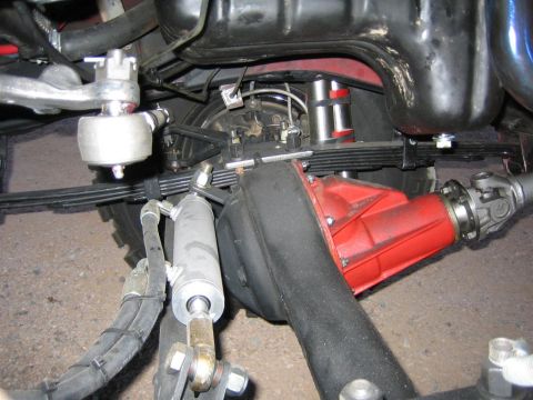1987 Suzuki Samurai - This image shows the undercarriage of a vehicle, focusing on suspension and drivetrain parts.
