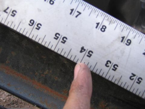 1987 Suzuki Samurai - A ruler measures a rusty metal bar, indicating a measurement of 5/4 inches.