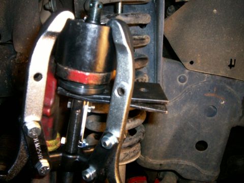 1993 Ford Bronco - 3-jaw puller pressing new bj into knuckle - note steel plates underneath bj to keep puller stud from puncturing new bj