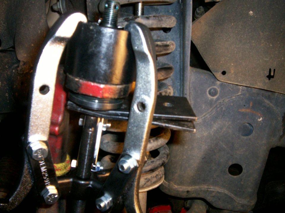 3-jaw puller pressing new bj into knuckle - note steel plates underneath bj to keep puller stud from puncturing new bj