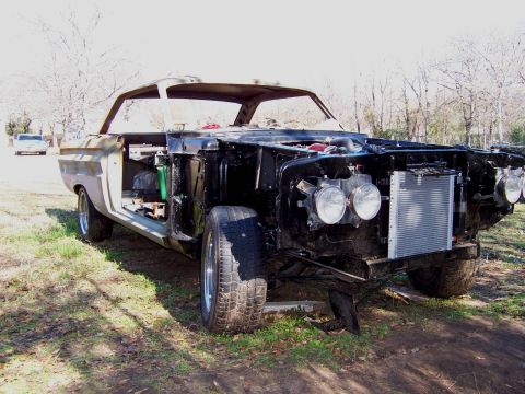 1964 Mercury Comet - 1964 Mercury Comet undergoing restoration, with the engine bay exposed and radiator visible.