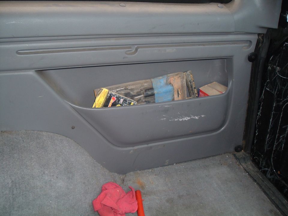 Interior storage compartment with tools and a red rag