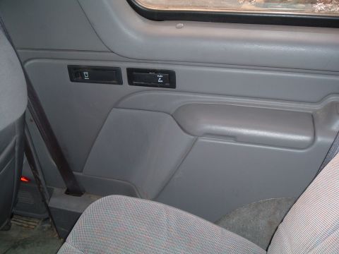 1995 Ford Bronco - Close-up of an interior door panel showing the switches and storage compartment.