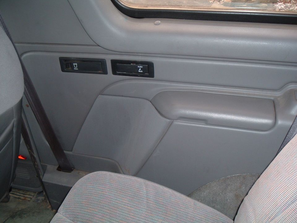 Interior door panel with power window and lock switches, and a pull handle