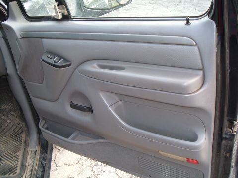 1995 Ford Bronco - Close-up view of the interior door panel and its features.