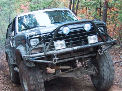 1995 Ford Bronco - This modified Ford Bronco, likely from the 1980s, is equipped for off-road use.