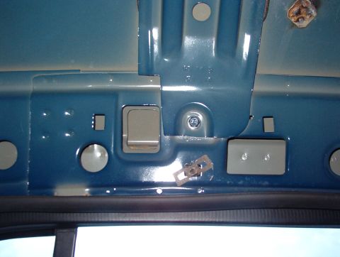 1999 Ford Crown Victoria - RHR roof bow. The 2 small rectangular holes on level with the bolt are for the grab handle. The clip nut below the bolt is for the hanger h…