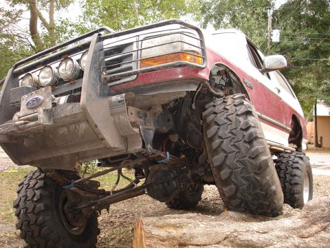 1989 Ford Bronco - This heavily modified Ford Bronco features oversized tires and a custom front brush guard, suggesting off-road capabilities.
