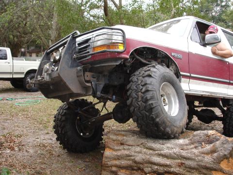1989 Ford Bronco - This modified Ford Bronco is positioned on a large log, its off-road capabilities.