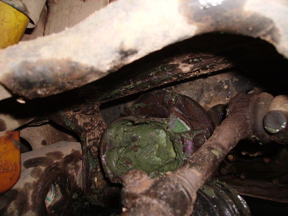 Grease-covered suspension part with yellow tag